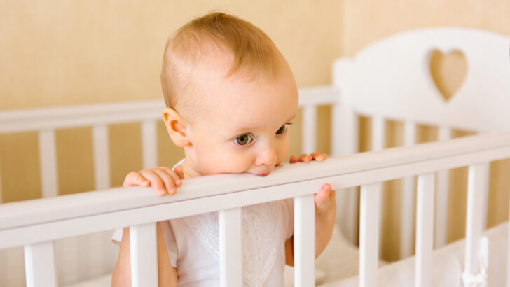 Baby Chewing On A Crib: Is She Playing Or Teething?